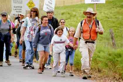 Julia and Larry Modell lead the group up the hill