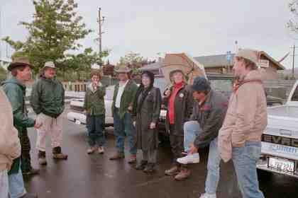 Group gathers in the rain at Prince Park -- walk or drive?