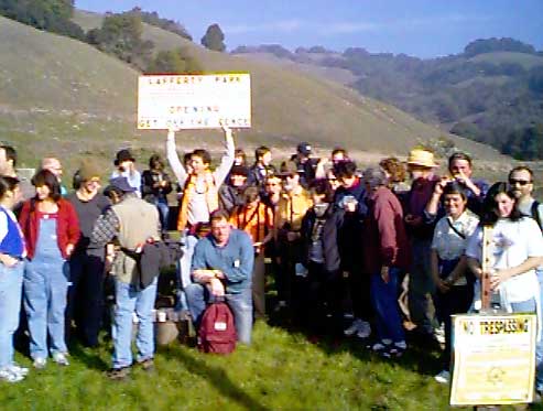 Walkers pose in front of their -- our -- land.