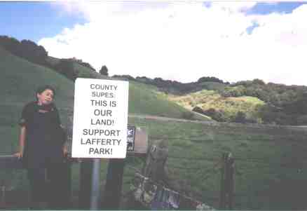Young marcher rests on the closed gate of Lafferty Park.
